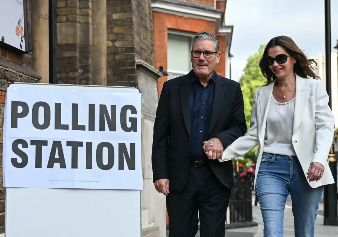 Britain's Prime Minister Keir Starmer (L) arrives with his wife Victoria Starmer (R) to cast their votes at a polling station in Westminster Chapel, central London, on 7 May 2026, as polls open for local elections. 