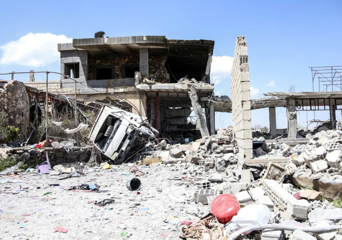 Locals survey the damage following a Jordanian strike on reported drugs and weapons storage facilities in the village of Busan, in the southern Druze-majority province of Sweida, on 2 May 2026.