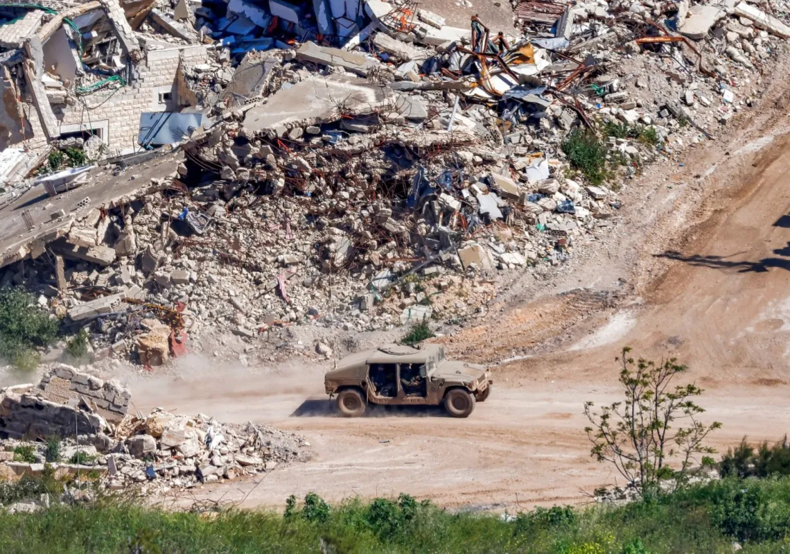An Israeli Humvee military vehicle drives past destroyed buildings in southern Lebanon as seen from across the border at a location in northern Israel on 7 May 2026. 