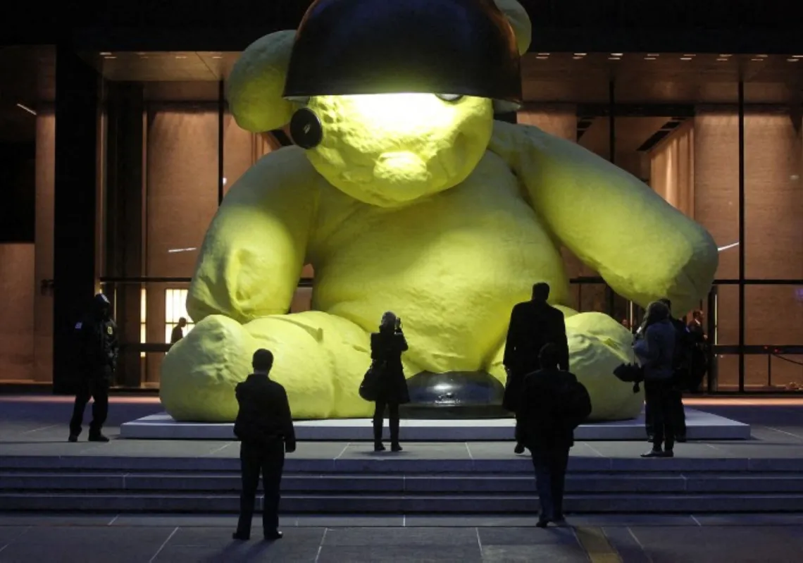 People view the 23-foot Lamp Bear outdoor sculpture of a teddy bear by artist Urs Fischer on 8 April 2011 in New York City.