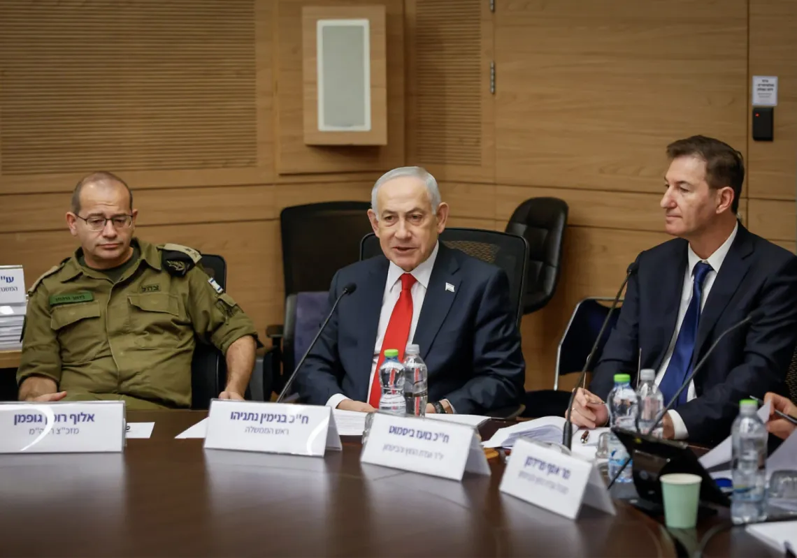 Prime Minister Benjamin Netanyahu (centre), his military secretary Roman Gofman (left) and Likud MK Boaz Bismuth attend a meeting in Jerusalem on 5 February 2026.