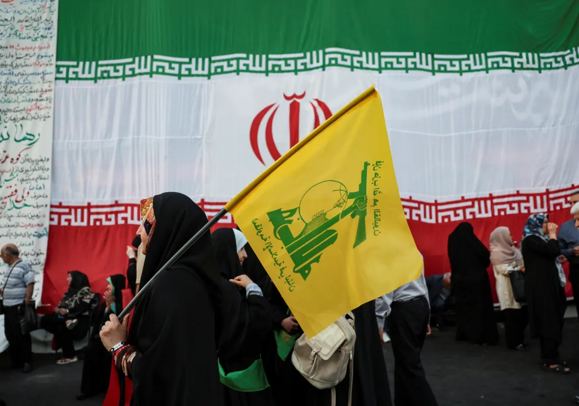A woman holds a Hezbollah flag during a rally in support of Iran's Supreme Leader, Mojtaba Khamenei, in Tehran, Iran, on 4 June 2026. 