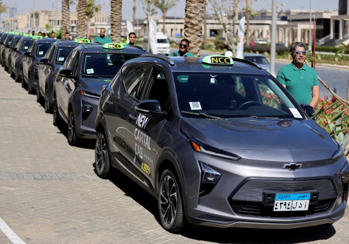 Drivers stand near electric cars, as Egypt began operating first electric taxis service, providing an eco-friendly ride-hailing solution for people in Cairo, on 16 May 2024. 
