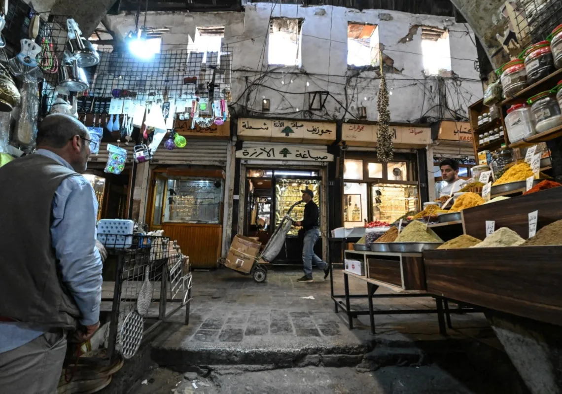 LOUAI BESHARA / AFP
Photo by LOUAI BESHARA / AFP
A worker pushes a hand truck past a shop selling spices at the old market in Damascus ahead of the Eid al-Adha holiday on 26 May 2026.