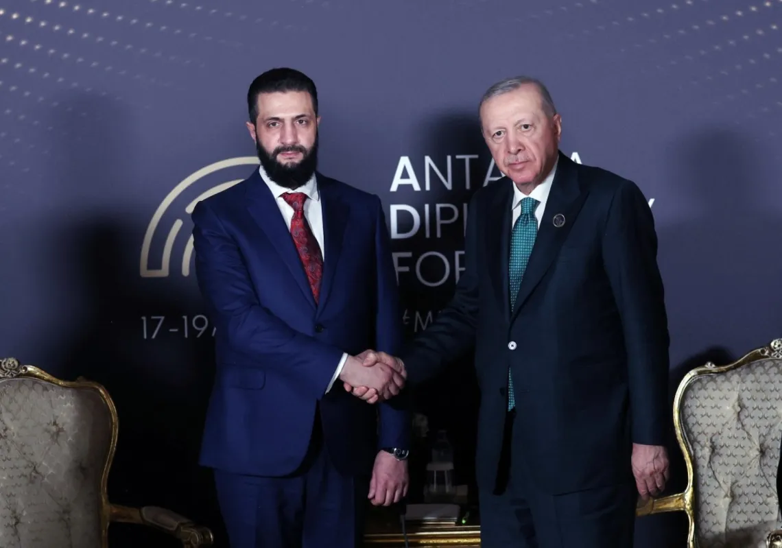 Türkiye's President Recep Tayyip Erdogan (R) greeting Syria's interim President Ahmed al-Sharaa (L) during the opening ceremony of the 5th edition of the three-day Antalya Diplomacy Forum (ADF2026) in Antalya on 17 April 2026.
