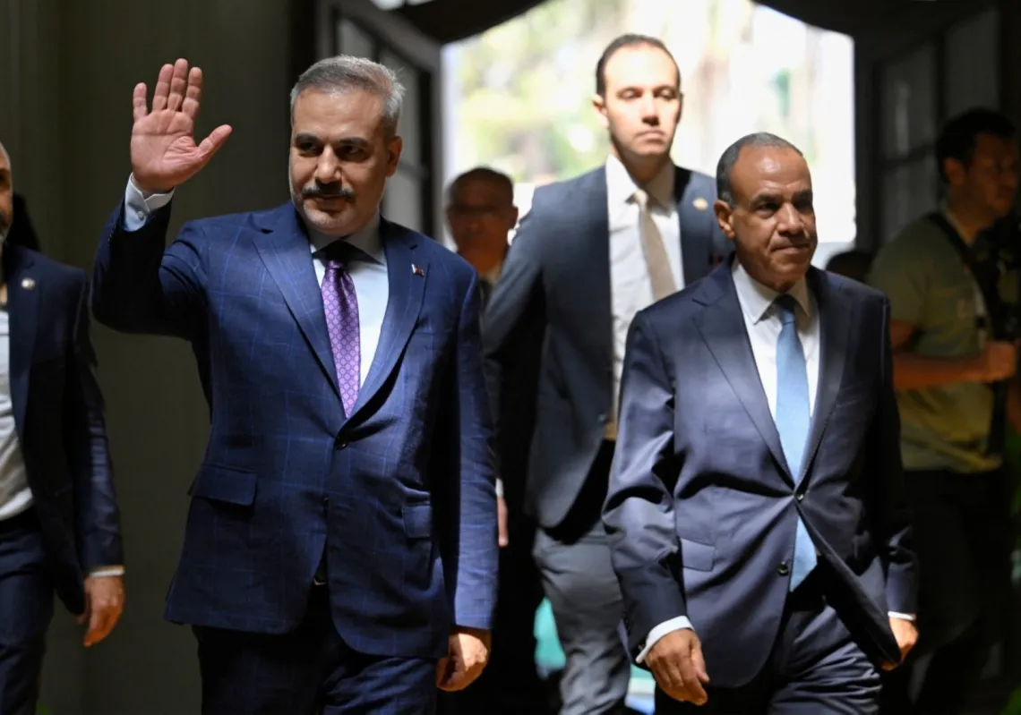 Egypt's Foreign Minister Badr Abdel Ati (R) walks with his Turkish counterpart Hakan Fidan (L) ahead of their meeting in Cairo on 21 June 2026.