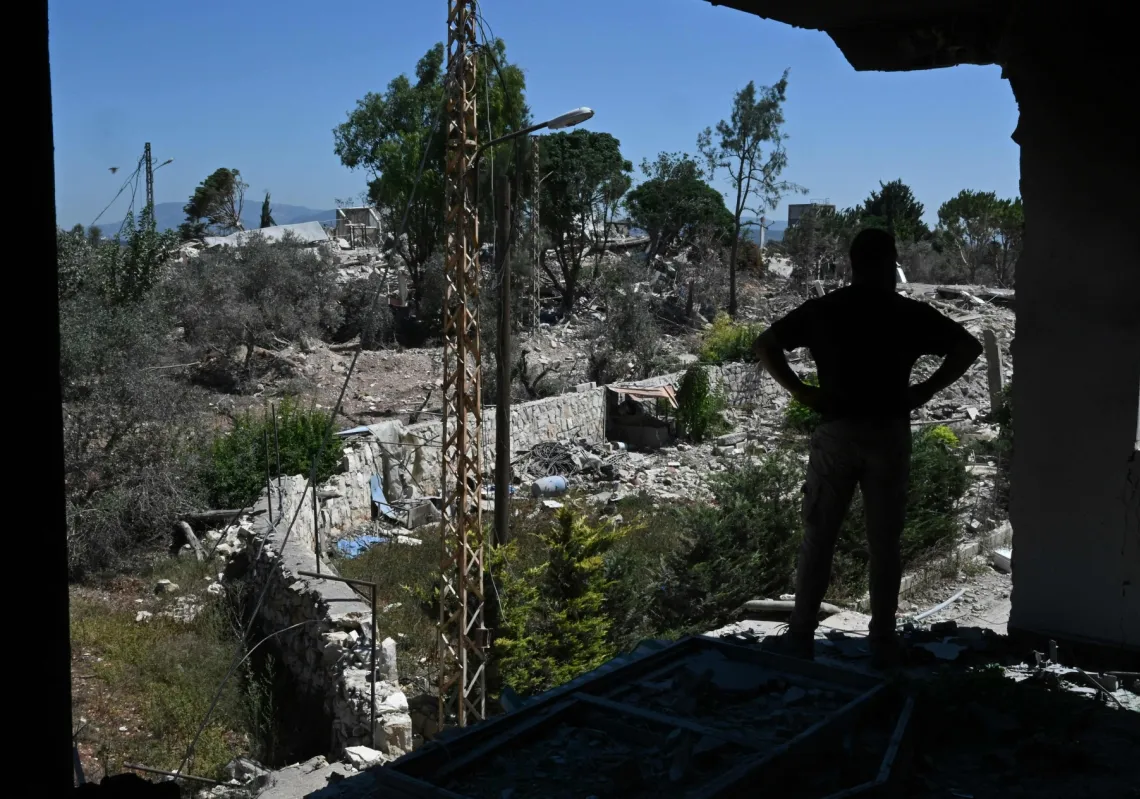 A man looks at the destruction from a damaged house as residents inspect their homes in Zawtar al-Gharbiya on 28 July 2026, after the Lebanese army deployed to the southern village.