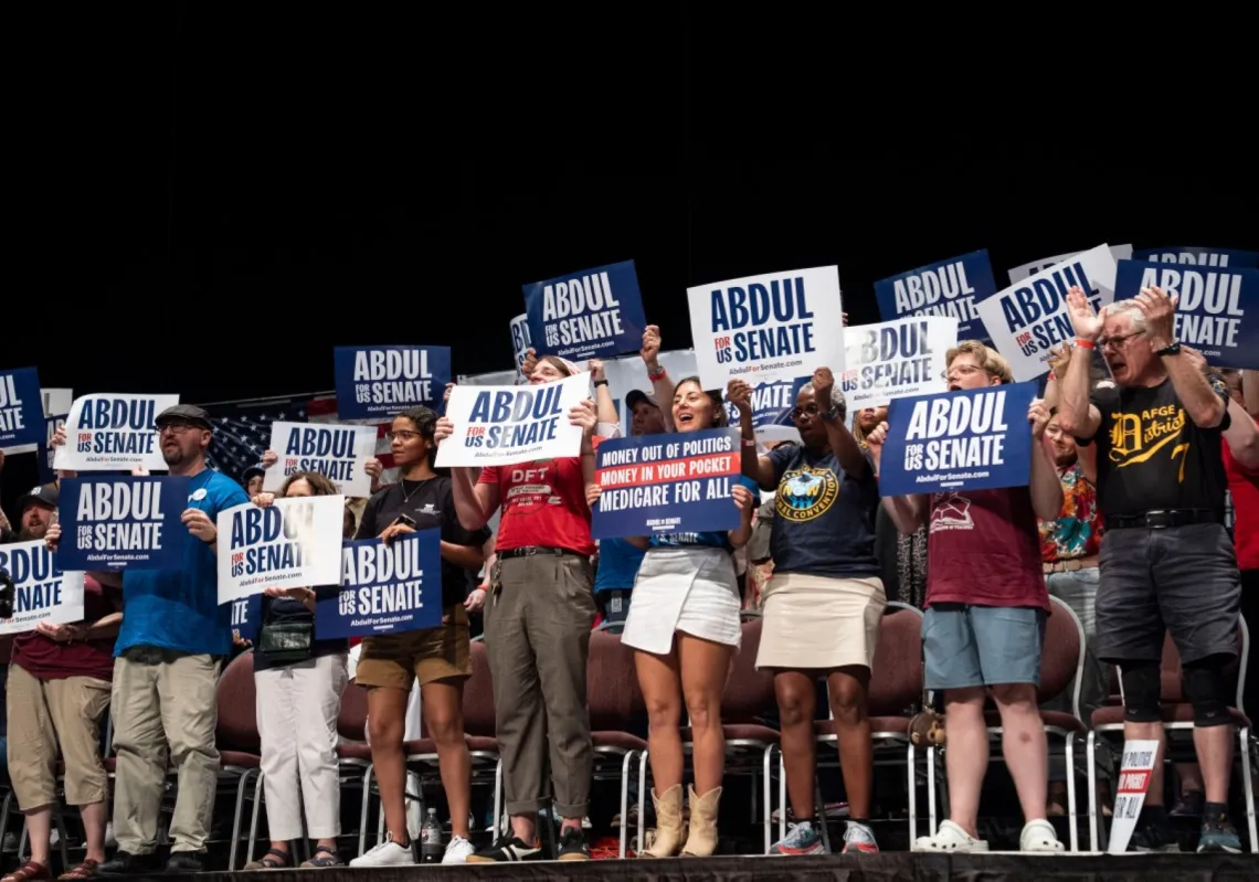 The audience cheers as US Rep. Alexandria Ocasio-Cortez speaks at The People V. The Powerful rally at the Detroit Opera House on 18 July 2026 in Detroit, Michigan.