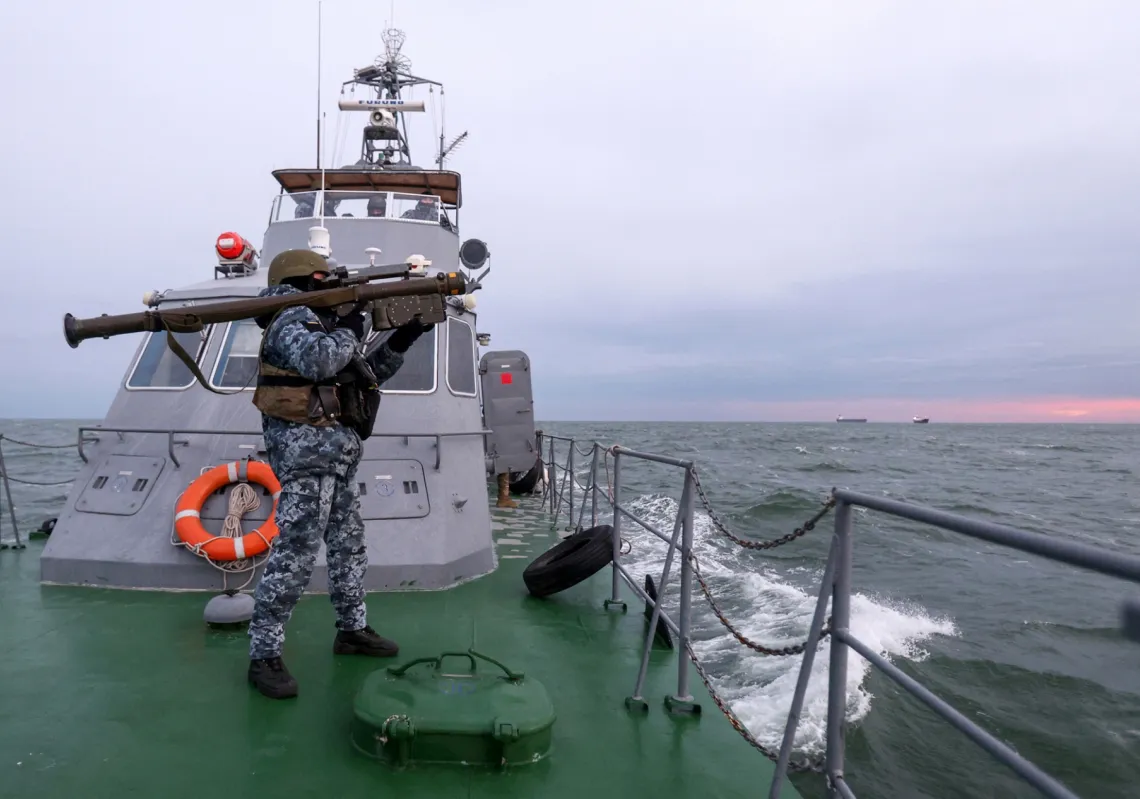 A Ukrainian soldier carrying a Stinger anti-aircraft missile aboard a maritime guard boat in the northwestern part of the Black Sea on 18 December 2023.
 