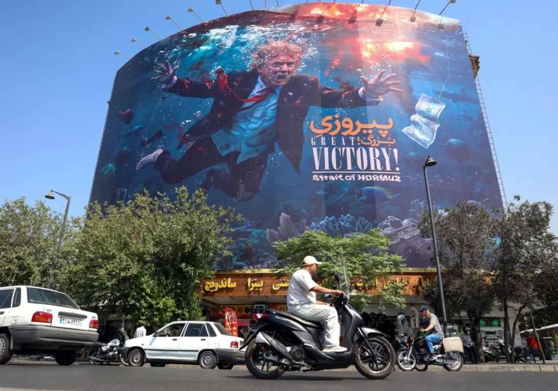 Motorists drive past a billboard in Tehran depicting Trump drowning in the Strait of Hormuz on 24 August 2026.