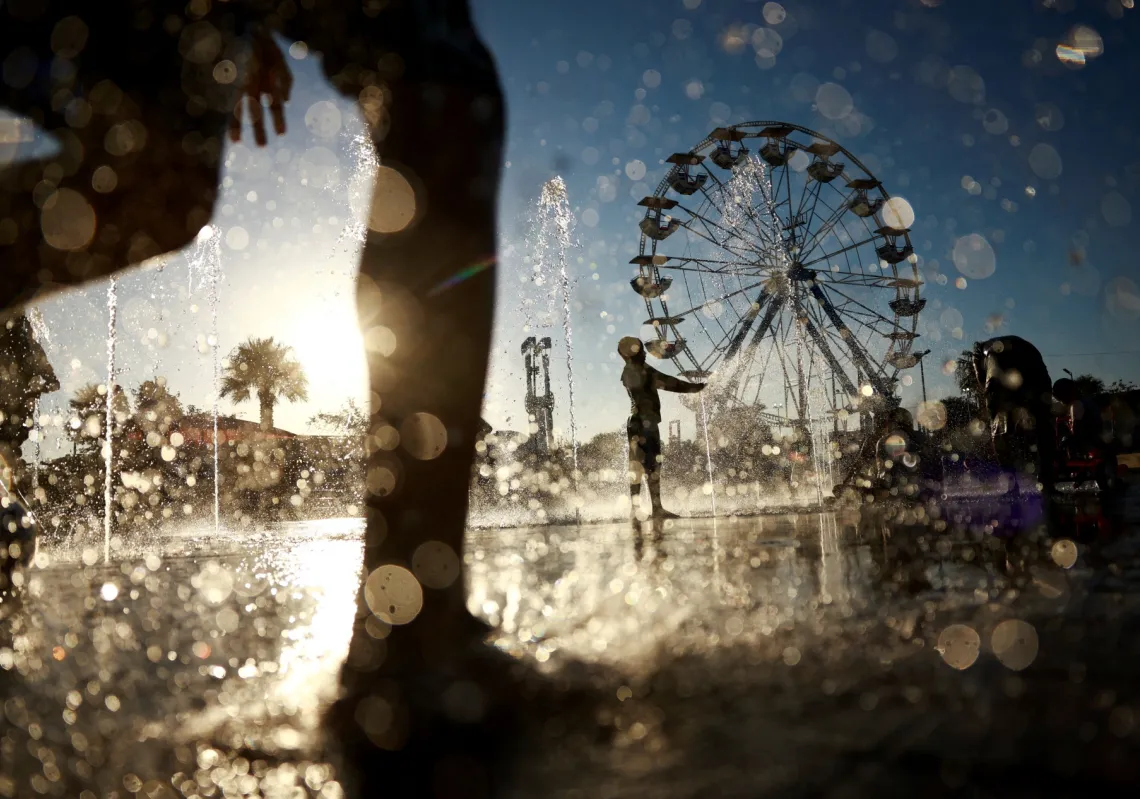 Children cool off in fountains at a park after a month of extreme heat in Ciudad Juárez, Mexico, on 30 July 2026. 