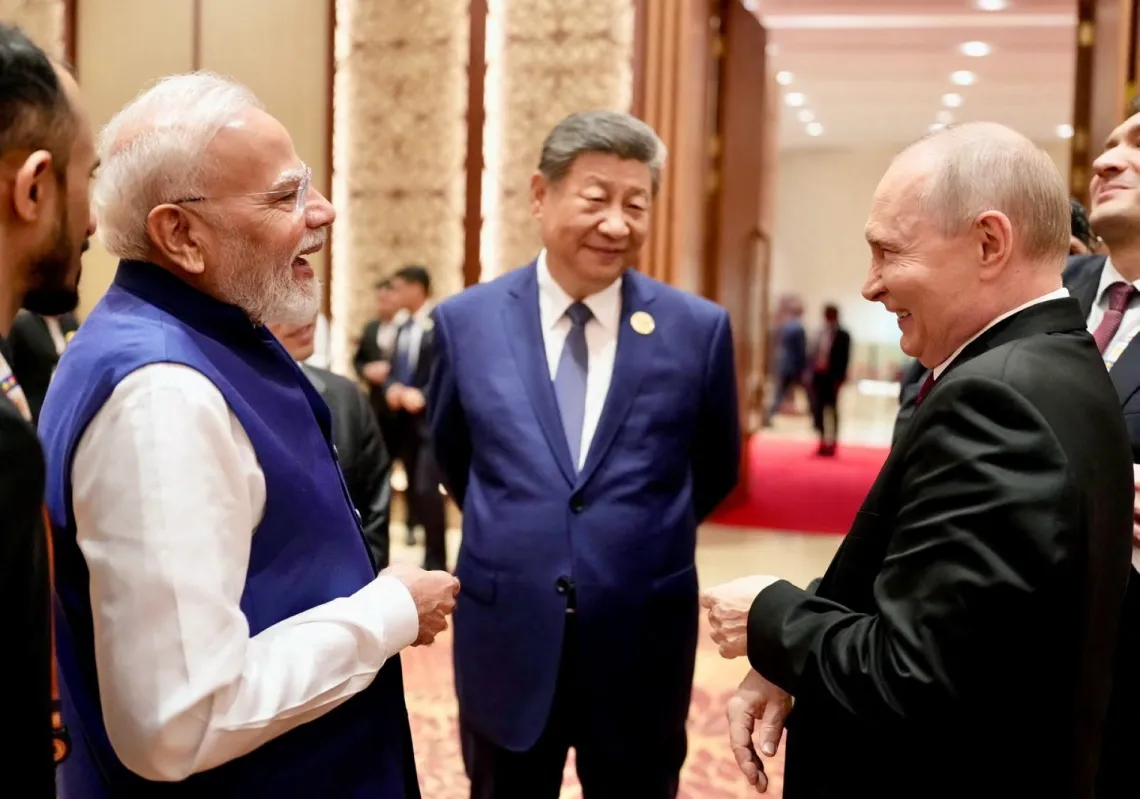 India's Prime Minister Narendra Modi shares a moment with Russian President Vladimir Putin as Chinese President Xi Jinping looks on during day two of the BRICS Summit in New Delhi, India, on 13 September 2026.
