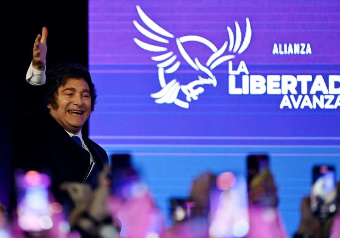 Argentina's President Javier Milei waves to supporters as he arrives at the ruling party's La Libertad Avanza headquarters following the results of the national midterm legislative election in Buenos Aires on 26 October 2025.