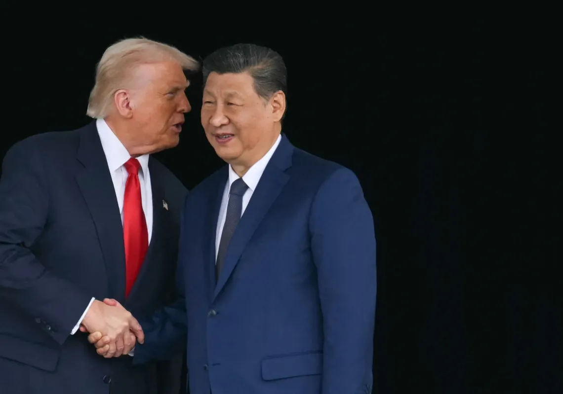 US President Donald Trump (L) and China's President Xi Jinping shake hands as they leave after their talks at the Gimhae Air Base, located next to the Gimhae International Airport in Busan on 30 October 2025.