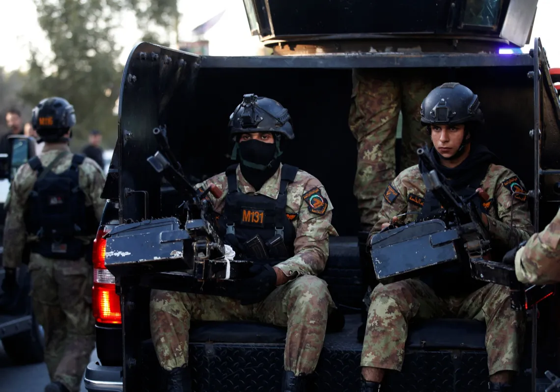 Members of Iraq's PMF keep guard on 8 February, 2024, during the funeral of Abu Baqr al-Saadi, a prominent leader in the Kataeb Hezbollah who was killed in an American drone strike on his car in Baghdad a day earlier.