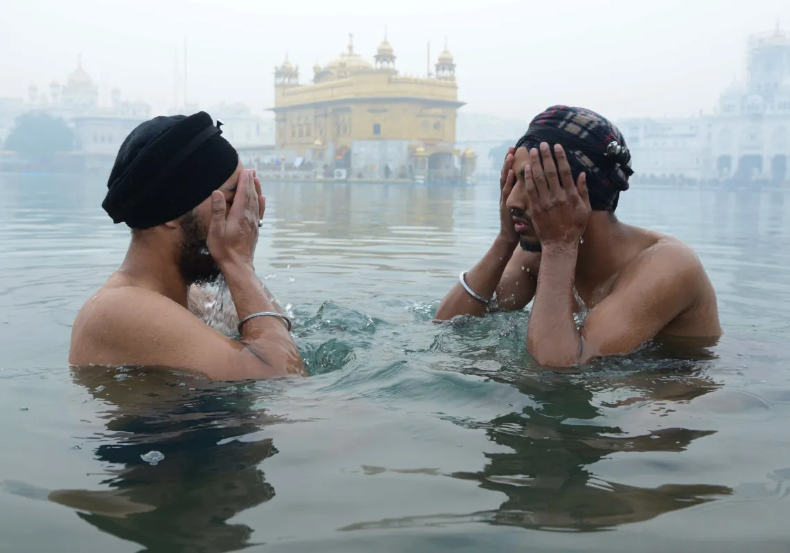 Indian Sikh devotees take a dip in the holy sarovar (water tank) in the early morning on the occasion of the New Year at the Sikh shrine Golden Temple in Amritsar on January 1, 2019. (Getty)