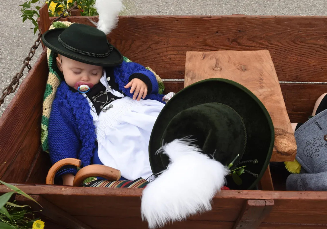A child sleeps in a cart during the traditional costume and riflemen parade on the second day of the 185th Oktoberfest beer festival on September 23, 2018 in Munich, southern Germany. - The world's biggest beer festival runs until October 7, 2018. (Getty)
